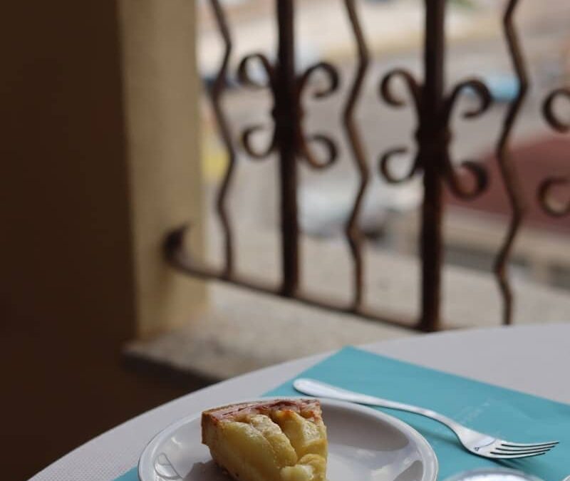 Delicious cake slice on a table overlooking a balcony.